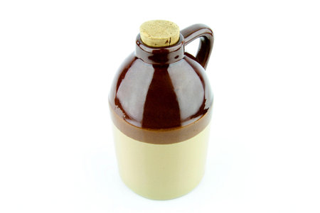 Old clay jug with a cork used to hold booze 
