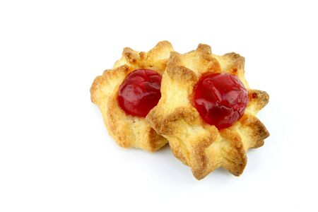 Cookie made of almonds with a red cherry on top, on a white background の写真素材
