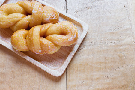 Bread, sugar-coated on a wooden table.