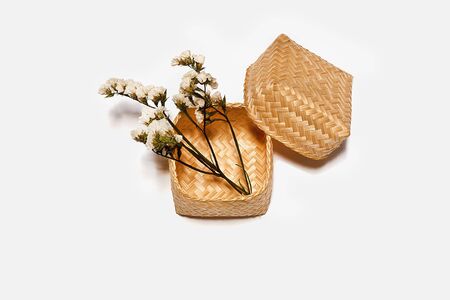 sticky rice container bamboo and white statice flowers on white backgroundの写真素材