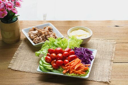 Tuna salad in plate on a wooden tableの写真素材