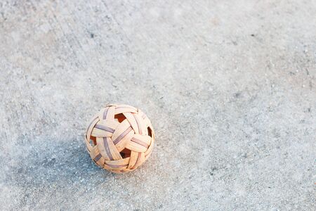 Old sepak takraw ball on concrete courts. Sports Equipment Traditional uses a rattan ball braided,Currently used Plastic ball, Rattan ball popular sport in asiaの写真素材