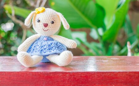 Knitted dolls on wooden table with soft focus and blur background. and with copy space.の写真素材