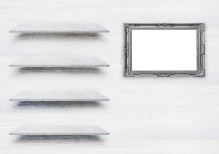 White wooden shelves and black antique frames on white wood plank texture for background. With copy space for design work and decorationの写真素材