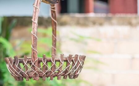 Empty wicker baskets hanging in the garden with soft focus and blur background.の写真素材