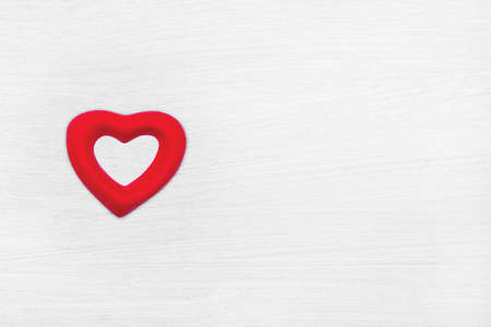 One red hearts on white wood plank texture for background. Valentines Day conceptの写真素材