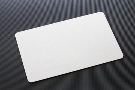Top view of blank white business card mockup with rounded corners on black textured background. Used for design as calling card, credit namecard display front used card design for business branding.の写真素材
