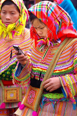 Lao Cai, Vietnam- January 02, 2011-The young woman girl with a mobile phone on the Sunday market in Lao Cai. Lao Cai, Vietnamのeditorial素材