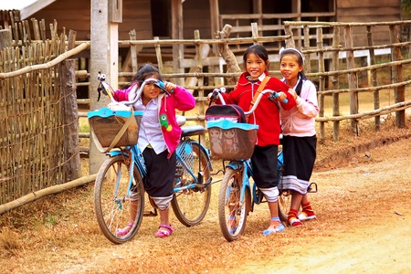 LAT SEN, LAOS- JANUARY 11: Girls with bicycles from the Lat Sen village. January 11, 2011 in Lat Sen, Laosのeditorial素材