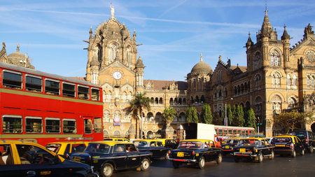 MUMBAI,INDIA - FEBRUARY13:Black-ye llow cabs in front of the Victoria Terminus. Designed by...