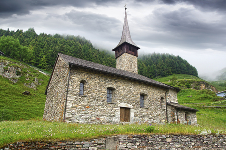 The beautiful mountain landscape with church. Andermatt, Switzerland.の写真素材