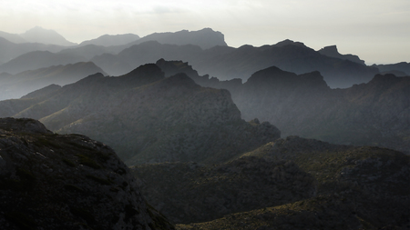 Silhouette mountains under mist in the evening.の写真素材