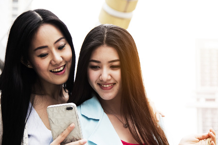 Beautiful women happy for take a photo on mobile phone on watercolor painting background.の写真素材