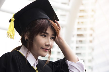 Beautiful girl students are happy after graduation.の写真素材