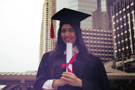 Beautiful girl students are happy after graduation.の写真素材