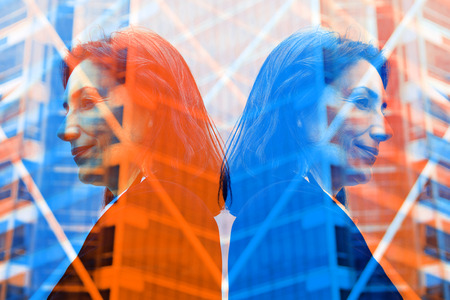 Beautiful business woman smiling and looking offices building background, blue color shape.の写真素材