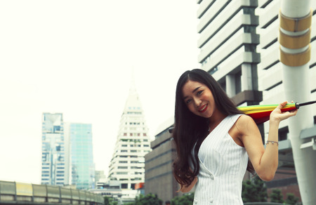 Beautiful women holding umbrella on the street city.の写真素材