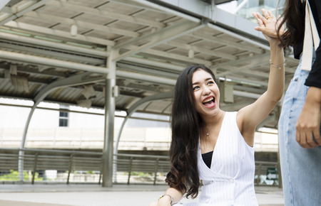 Beautiful woman very happy with friends on walking street in the city.の写真素材