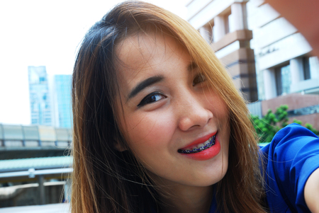 Close-up woman smile selfie portrait and traveling in the city.の写真素材