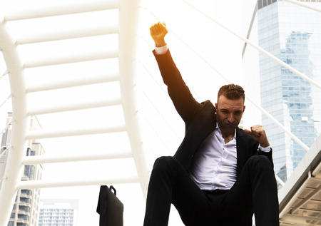 Business man show hand success concept and building background.の写真素材