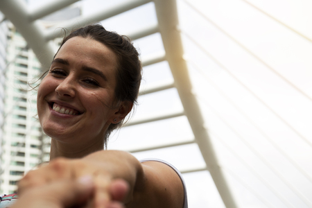 Beautiful women smile portrait and holding boyfriend on walking street.の写真素材