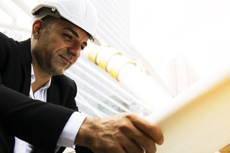 Close-up engineering man looking structure plan on paper.の写真素材