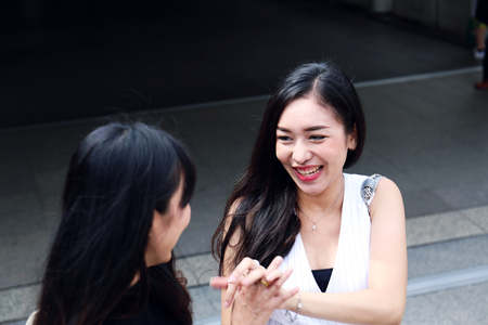 Beautiful Asia woman very happy with girlfriend for traveling vacations on walking street in the captal city.の写真素材