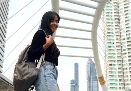 Beautiful Asia woman happy and traveling in the capital city and walking on street.