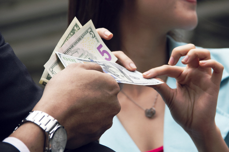 Beautiful woman happy get money from boyfriend for shopping and traveling in holiday weekend.の写真素材