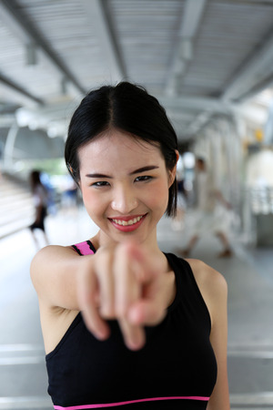 Close-up beautiful sport girl smile portrait on walking street.の写真素材