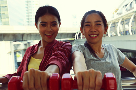 Close-up beautiful Sport woman holding weight.の写真素材