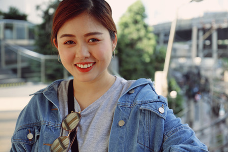 Beautiful Asia woman smile portrait and traveling in city.の写真素材