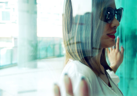close-up beautiful woman smile portrait and looking glass, Blur and soft light foreground.