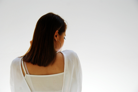 Beautiful the back of the woman portrait and white color building background.の写真素材