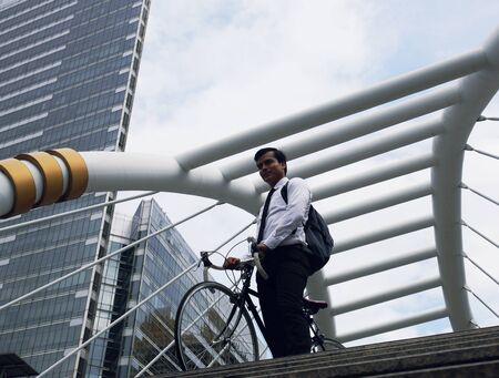 Business man worker riding bicycles on walking street in the capital city.の写真素材
