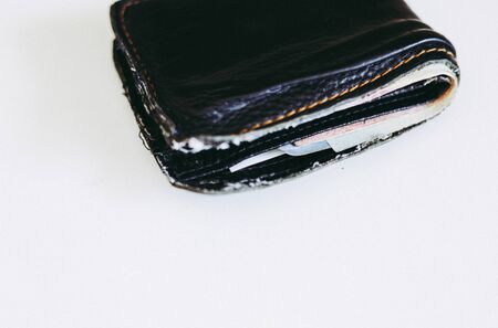 Close-up old purse on a white table.の写真素材