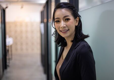 Beautiful business woman smile portrait and standing in the offices.の写真素材