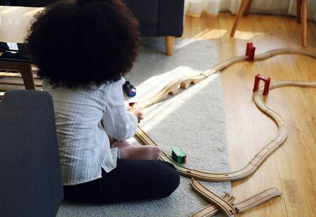 Beautiful kid girl playing in summer weekend in home.の写真素材