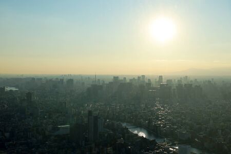 Beautiful city landscape of Tokyo city in the sunrise and à¸aint fog, cover the wind.の写真素材