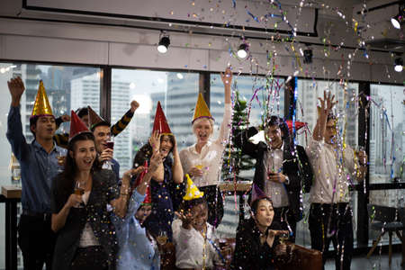 Smiling young Business people on New Year Party in Office and drinking champagne for New Year celebration.の写真素材