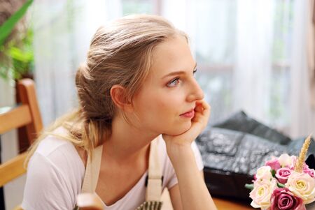 Beautiful young woman is preparing to cooking in kitchen room.の写真素材