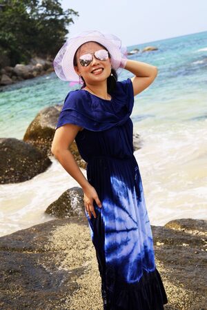 Beautiful Asia young woman smile portrait on the beach in summer at Phuket, Thailand.の写真素材