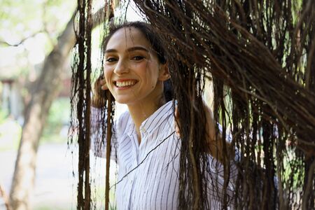 Beautiful young woman walking and happiness traveling in the forest at the capital city.の写真素材
