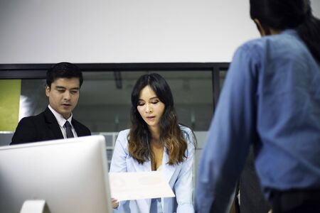 Young Asia business woman working and meeting present information at desk.の写真素材