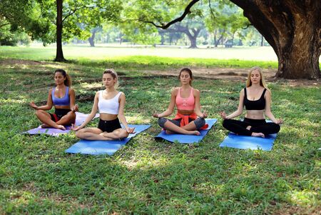 Happiness portrait young woman exercise yoga in morning at garden park.の写真素材
