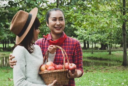 Beautiful family mother and daughter are walking in summer at the garden park.の写真素材