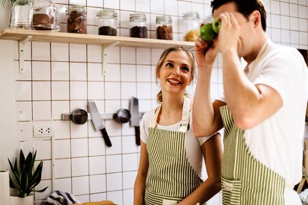 Young couples are enjoying cooking at the kitchen in working from home, COVID-19.の写真素材