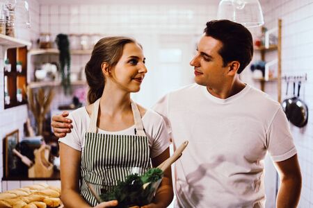 Young couples are enjoying cooking at the kitchen in working from home, COVID-19.の写真素材