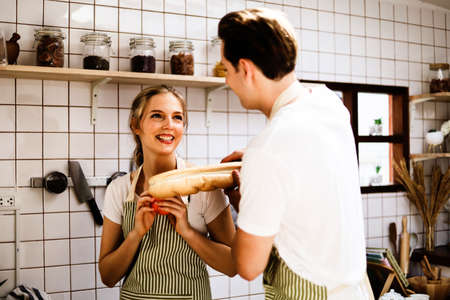 Young couples are enjoying cooking at the kitchen in working from home, COVID-19.の写真素材