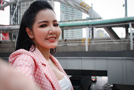 Happiness young business woman smile portrait and working at outdoors.の写真素材
